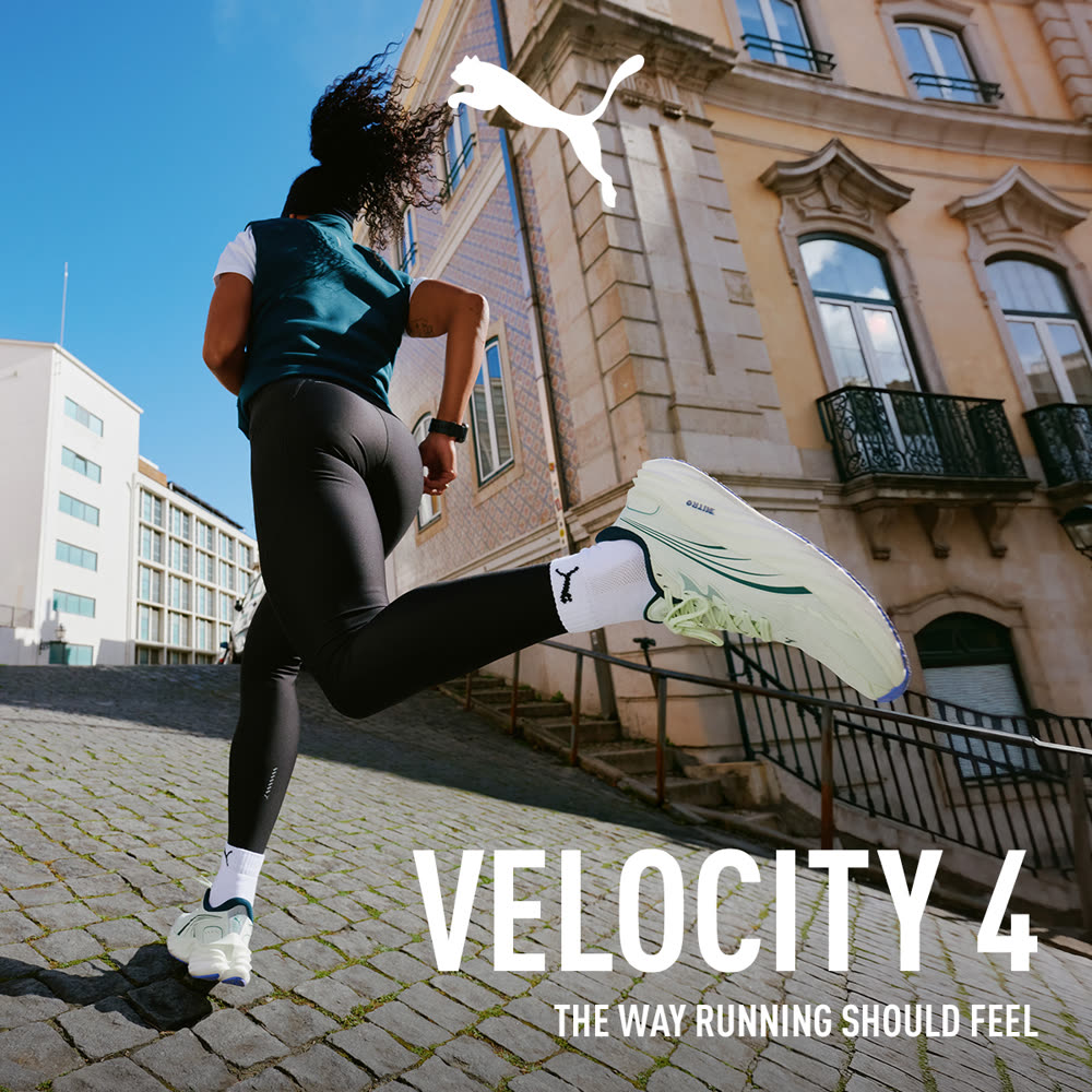 Original campaign still: a runner sprinting up a cobbled European street, English tagline reading 'The way running should feel'