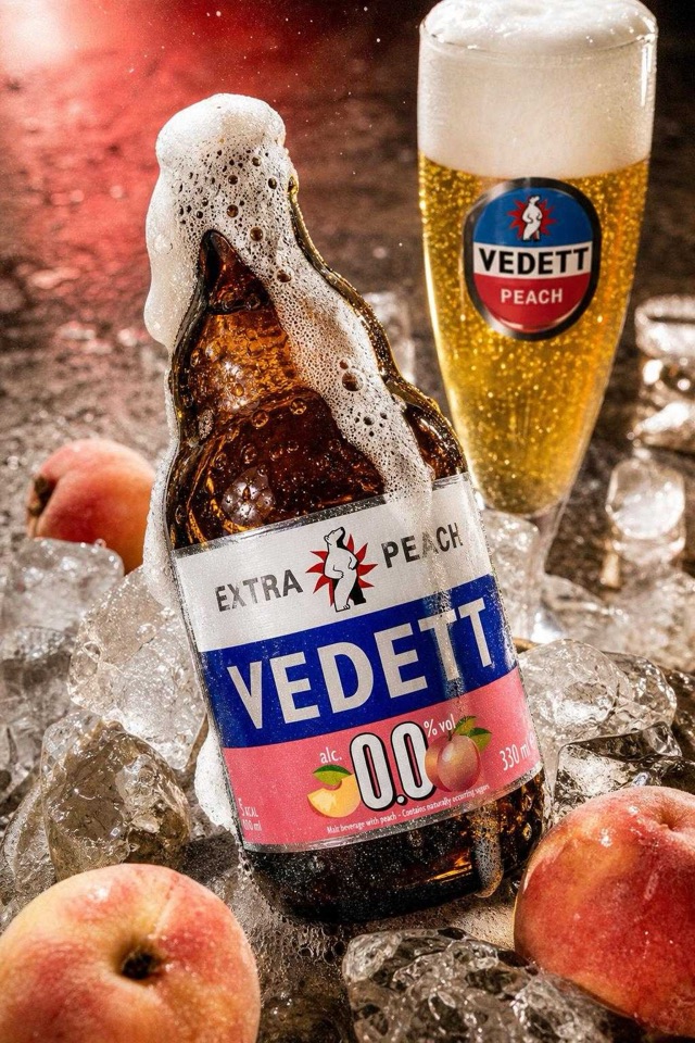 AI campaign look: peach beer bottle in a wet-splash treatment